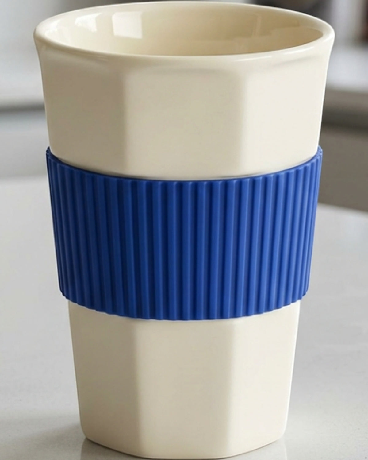 Kpbxg Six-Facet Ceramic Water Cup with Silicone Grip Sleeve 14 oz Ivory Cobalt - Lifestyle view